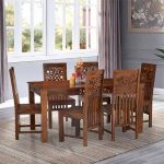 Handmade sheesham wood dining table with intricate details.